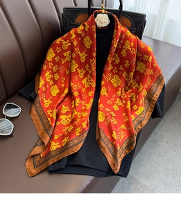 Detail of red silk scarf with golden Fu characters and traditional Chinese border pattern