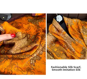 Détail du foulard en soie orange avec motifs floraux dorés et nuages traditionnels