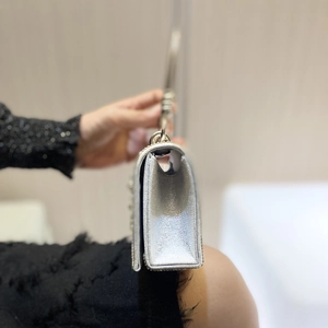 Silver metallic rhinestone evening bag with round handle and triangle pleated side view