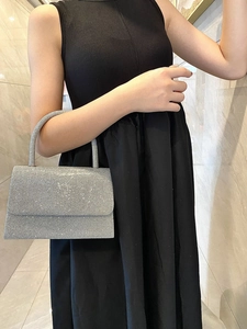 Detail of sparkling silver evening bag with rhinestones and elegant round handle