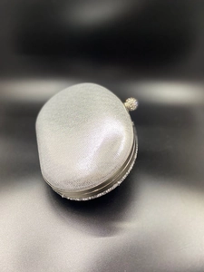 Macro view of shell evening bag with silver glitter fabric and crystal frame details