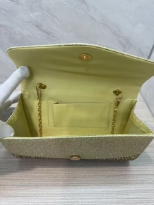 Elegant gold glitter evening clutch bag with metallic chain strap and satin interior lining