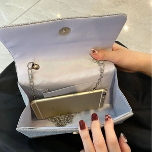 Sparkly silver glitter evening clutch bag with metal chain strap and spacious interior