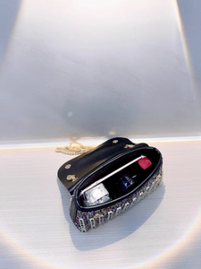 Internal view of a black rhinestone evening bag showing space for phone and makeup