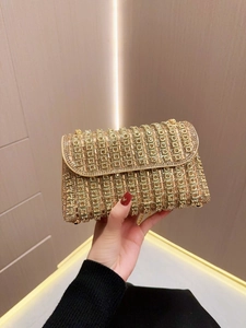 Detailed view of the gold rhinestone evening clutch with elegant flip-top closure