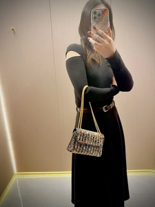 Close-up of colorful rhinestones on evening clutch bag with gold chain straps