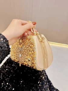 Luxurious gold evening clutch bag with sparkling rhinestones and metal handle for parties