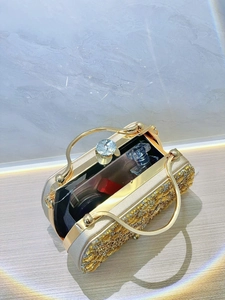 Detail of evening clutch interior showing gold metal handle and rhinestone embellishments