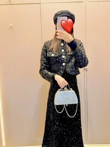 Detail of silver rhinestone evening bag paired with black sequin two-piece set