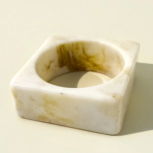 Macro detail of geometric resin bangle with marble texture and leopard print hues