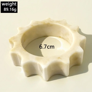 Detail of resin bangle with marble texture showing 6.7cm inner diameter and gear-like design