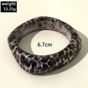 Detail shot of chunky resin leopard print bangle showing 6.7cm diameter and 53.25g weight