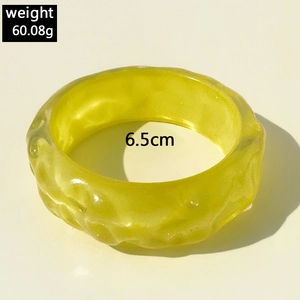 Irregular textured light green resin bangle with glitter finish and 6.5cm diameter