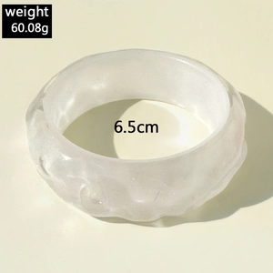 Detail view of white resin cuff bangle with textured hammered finish and 6.5cm diameter