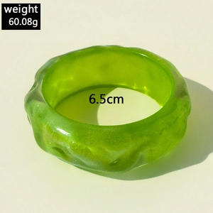 Detailed view of green glitter resin bangle showing 60.08g weight and 6.5cm diameter