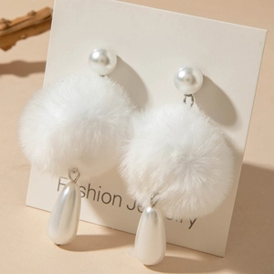 Detail of white plush ball earrings with elegant drop pearl and round pearl studs