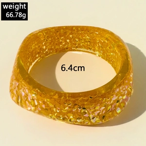 Close-up of square yellow resin bangle with gold foil glitter, 6.4cm inner diameter