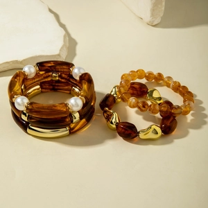 Detailed view of bohemian resin bead bracelets with pearls and golden alloy accents
