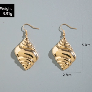 Detailed view of golden seashell earrings with precise size measurements and polished texture
