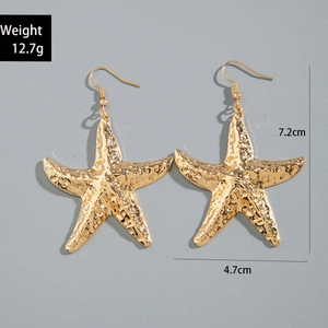 Detailed view of gold starfish drop earrings showing 7.2cm length and textured surface
