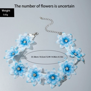 Close-up of blue floral choker with fabric petals and sparkling crystal centers