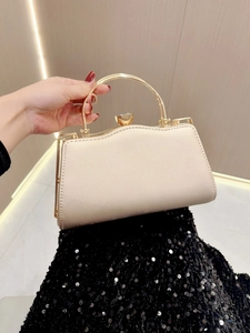 Detail of cream evening bag with sparkling rhinestones and gold handle for gala events