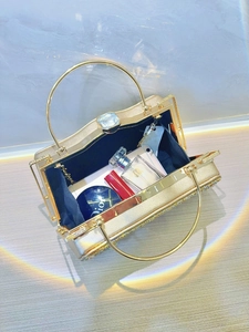 Golden rhinestone evening bag with round handle showing spacious inner storage