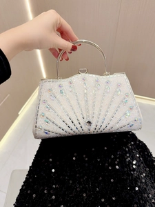 Close-up of evening clutch bag featuring radial rhinestones and a large center crystal