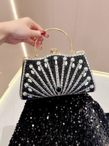 Detail view of luxurious evening bag featuring colorful rhinestones and gold handle