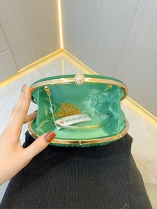 Green sequined evening clutch bag with sparkling diamond clasp and gold chain strap