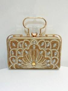 Detailed pattern of fans and flowers with gold crystals and pearls on evening handbag
