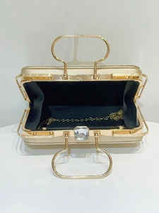 Golden hard shell evening clutch with large crystal clasp and gold chain strap
