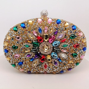 Oval evening clutch bag with colorful rhinestones and sparkling crystals on gold frame