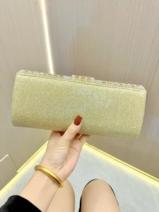 Sparkly gold evening clutch bag with rhinestone clasp and glitter finish for formal gala