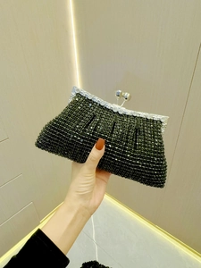Close-up of black rhinestones evening bag with silver metal frame and ball clasp