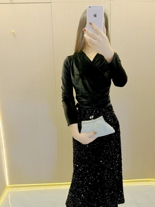 Close-up of elegant silver trapezoidal clutch bag with sparkling rhinestones for evening gala