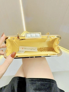 Elegant gold evening clutch with sparkling rhinestone clasp and detachable chain strap