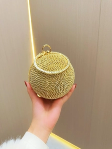 Elegant gold spherical evening clutch bag with sparkling white crystals and metal handle