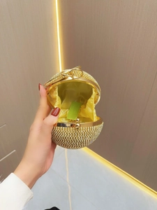 Elegant gold spherical evening clutch bag encrusted with sparkling rhinestones and chain
