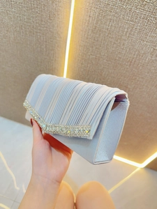 Elegant pleated evening clutch bag with sparkling rhinestone trim and satin finish