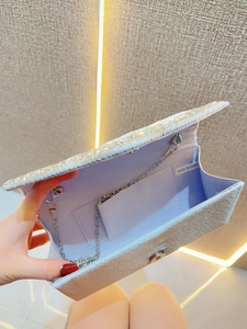 Sparkling rhinestone clutch bag with silver pearlescent fabric and metal chain