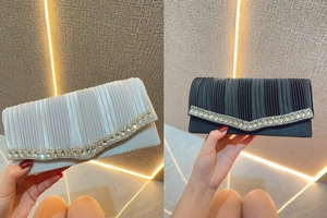 Detail view of rhinestone-embellished evening clutch bags with pleated texture in silver and black