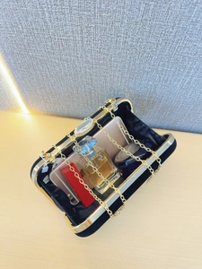 Elegant black velvet evening clutch with gold metal frame showing internal capacity