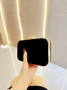 Elegant black velvet evening clutch with gold metal frame and sparkling crystal clasp