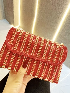 Elegant red bridal evening bag with sparkling rhinestones and gold chain shoulder strap
