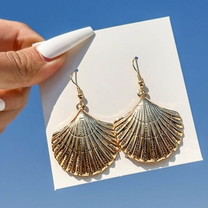 Golden seashell drop earrings for summer beach style with a polished metallic finish
