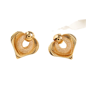 Golden heart earrings with radial texture and woven mesh center on white background