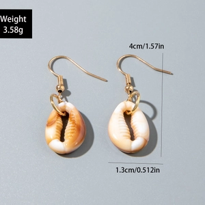Detailed view of natural shell earrings with gold hooks and specific size measurements