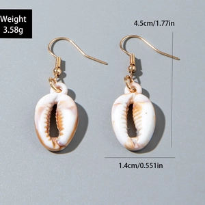 Detailed view of bohemian cowrie shell earrings with gold hooks and product dimensions