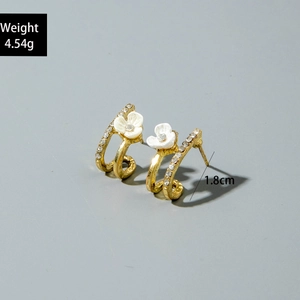 Detail view of 1.8cm gold C-shaped flower earrings with rhinestones weighing 4.54g